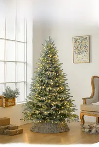 Close-up of premium PE artificial Christmas tree with warm white LED lights and wicker base