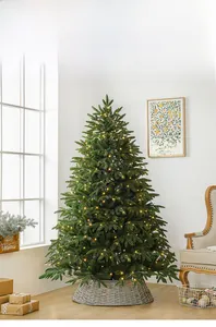 Detailed view of artificial Christmas tree with warm LED lights and grey wicker tree base