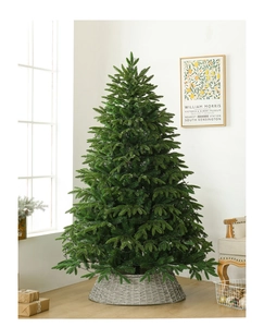 Close-up of a dense PE artificial Christmas tree with a woven cone base in a home setting