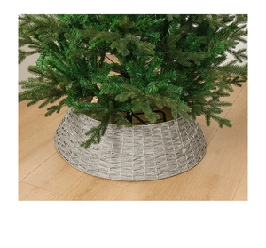 Close-up of gray woven Christmas tree collar base cover on wooden floor interior