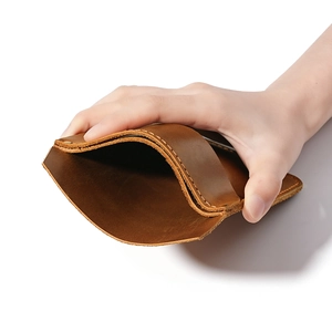 Handmade brown leather pocket organizer pouch showing flexible texture and hand-stitched detail