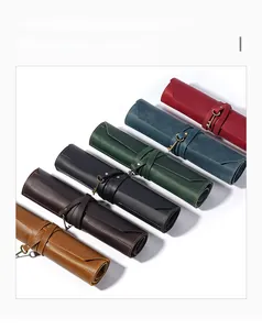 Macro detail of genuine leather pen rolls with vintage key charms in multiple colors