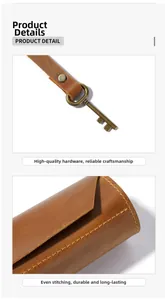 Close-up of vintage brown leather pen wrap with antique bronze hardware and stitching