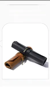 Detail view of crazy horse leather roll-up tool pouch with strap closure and key ring