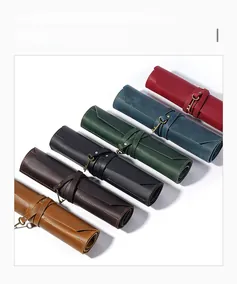 Detail showing vintage roll-up leather pouches in six colors with key pendant closure
