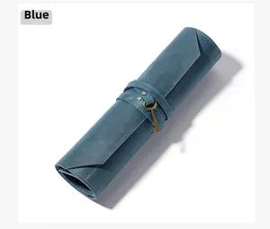 Detail view of a vintage blue leather tool roll with a retro gold key metal buckle