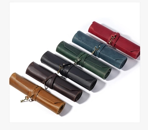 Macro detail of leather tool rolls in six colors featuring vintage metal key charms