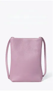Detailed view of purple lychee pattern leather phone bag with slim shoulder strap