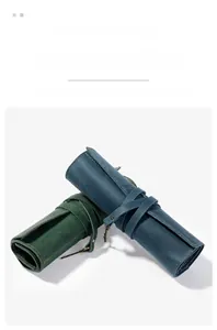 Detail of vintage crazy horse leather pencil rolls in dark green and deep blue colors