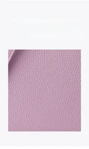 Detailed macro view of purple lychee pattern genuine leather material on handbag