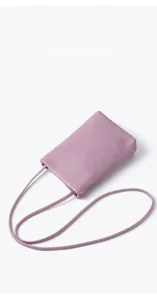 Close-up of light purple leather phone bag featuring a premium lychee grain texture