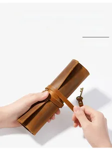 Detail of vintage brown genuine leather roll pouch with leather cord closure wrap
