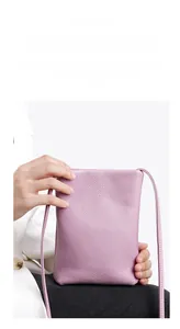 Detail of light purple leather phone bag with premium pebbled texture and slim strap