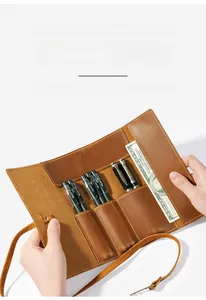 Macro detail of crazy horse leather roll-up pencil case with multiple pen slots and tie