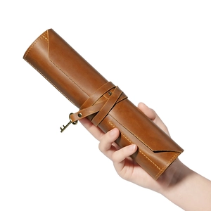 Vintage brown leather roll-up tool pouch with metal key charm and wrap-around strap