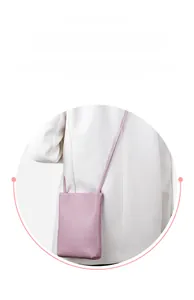 Detail of pink pebbled leather mini crossbody phone bag with slim shoulder strap