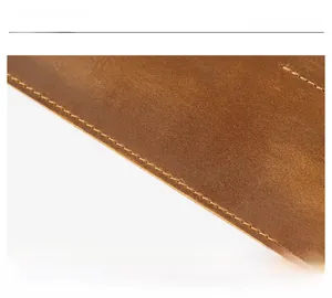 Macro shot of crazy horse leather texture with neat stitching detail on a brown pen case