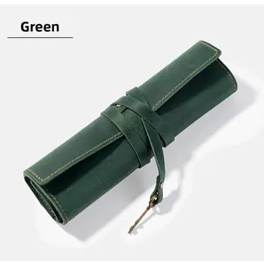 Detail of crazy horse leather pen roll with yellow stitching and key pendant