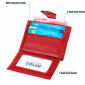 Detail of red leather RFID wallet with transparent ID window and card slots with white stitching