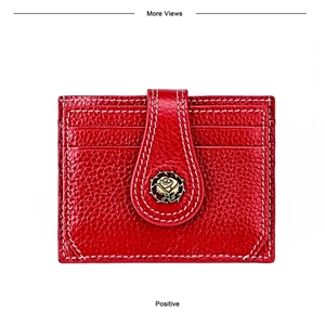 Detail of red lychee grain leather wallet featuring a bronze rose logo and white stitching
