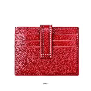 Macro view of the red litchi grain leather card holder showing back slots and white stitching