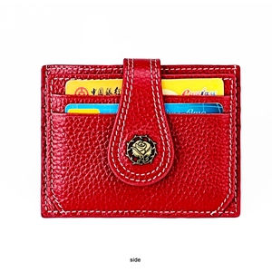 Detail of red pebbled leather card holder with vintage rose metal clasp and card slots