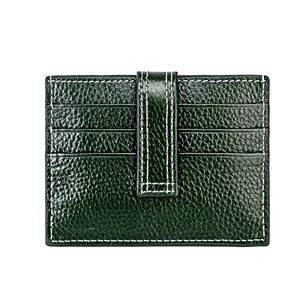 Close-up of green pebble leather card holder with contrast stitching and secure snap closure