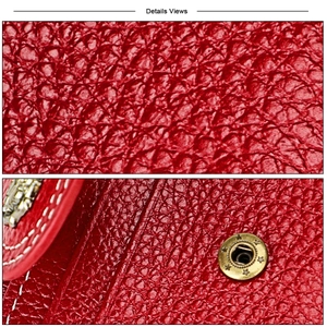 Macro detail of red pebble leather wallet with white stitching and star metal snap button