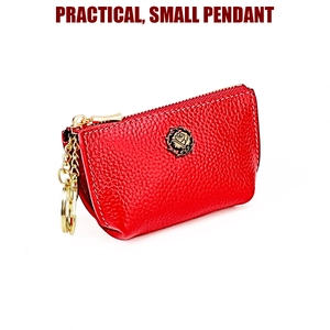Detailed macro view of red pebbled leather coin purse with golden rose emblem and zipper