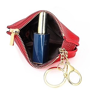 Detail of red pebbled leather coin purse showing interior capacity with a lipstick