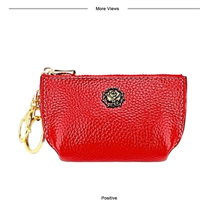 Detailed view of red pebble leather coin purse featuring a golden rose metal emblem