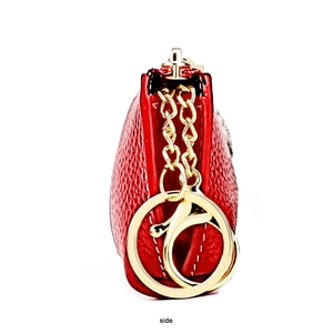 Side view of red pebble leather coin purse with golden hardware and detailed stitching