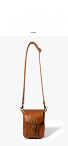 Detail of adjustable leather shoulder strap on a vintage crazy horse cowhide bag
