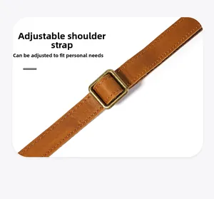 Detail of adjustable crazy horse leather shoulder strap with antique bronze metal buckle