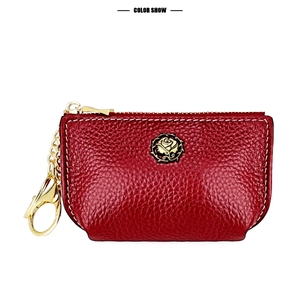 Detail of red lychee grain leather coin purse featuring golden rose logo and lobster clasp