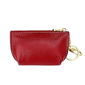 Detail of red lychee grain leather coin purse with gold zipper and white stitching