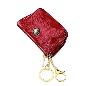 Detail of red genuine leather coin purse showing lychee texture and gold metal rose logo