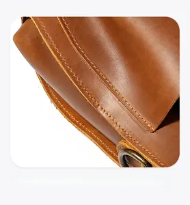 Detailed macro view showing the parallel double stitching on brown crazy horse leather