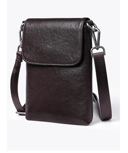 Detail of vegetable tanned leather phone bag featuring retro metal hooks and nylon strap