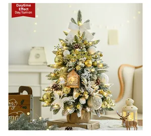 Detail of mini snowy Christmas tree with LED lights, pine cones, and burlap base