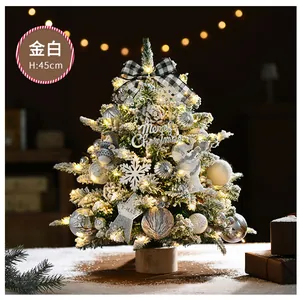 Close-up of a 45cm mini gold and white Christmas tree with LED lights and pine cones