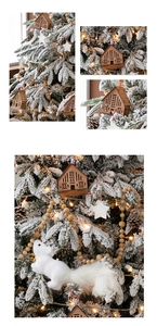 Detail of wooden cabin ornament and plush white squirrel hanging on a snowy Christmas tree