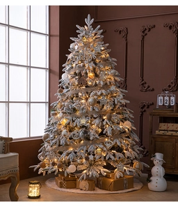 Detail of flocked Christmas tree with warm LED lights and rustic wooden star ornaments