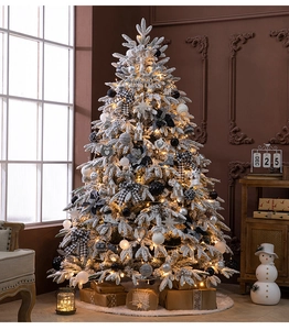 Detail of a 1.8m flocked Christmas tree with white snow, LED lights and black-white ornaments