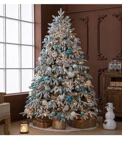 Close-up of frosted Christmas tree with blue ornaments and warm LED lights
