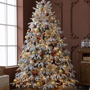 Flocked white snowflake Christmas tree with warm LED lights and gold ornaments