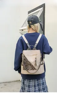 Leopard print patchwork backpack worn by a model in a casual street setting