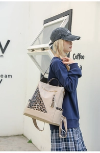 Detail of trendy leopard print backpack showing side panel and stylish tassel zipper pull