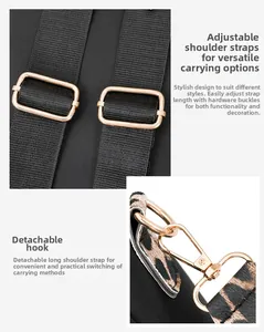 Detail of adjustable nylon straps and gold metal hooks on a leopard print backpack