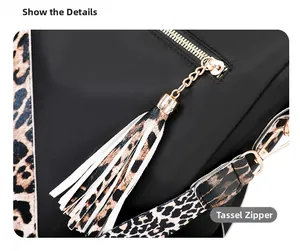 Detail of a black backpack with high-quality gold zipper and trendy leopard print tassel